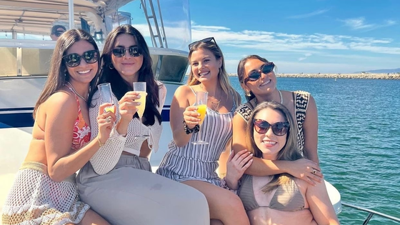Friends sipping drinks on their Los Angeles private yacht cruise
